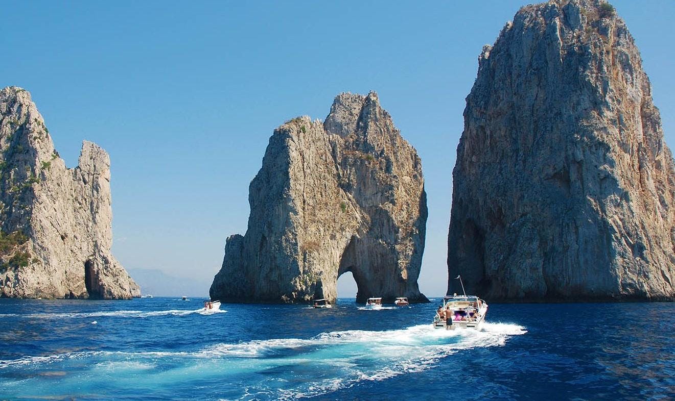A boat is headed to the wonderful Faraglioni of Capri.