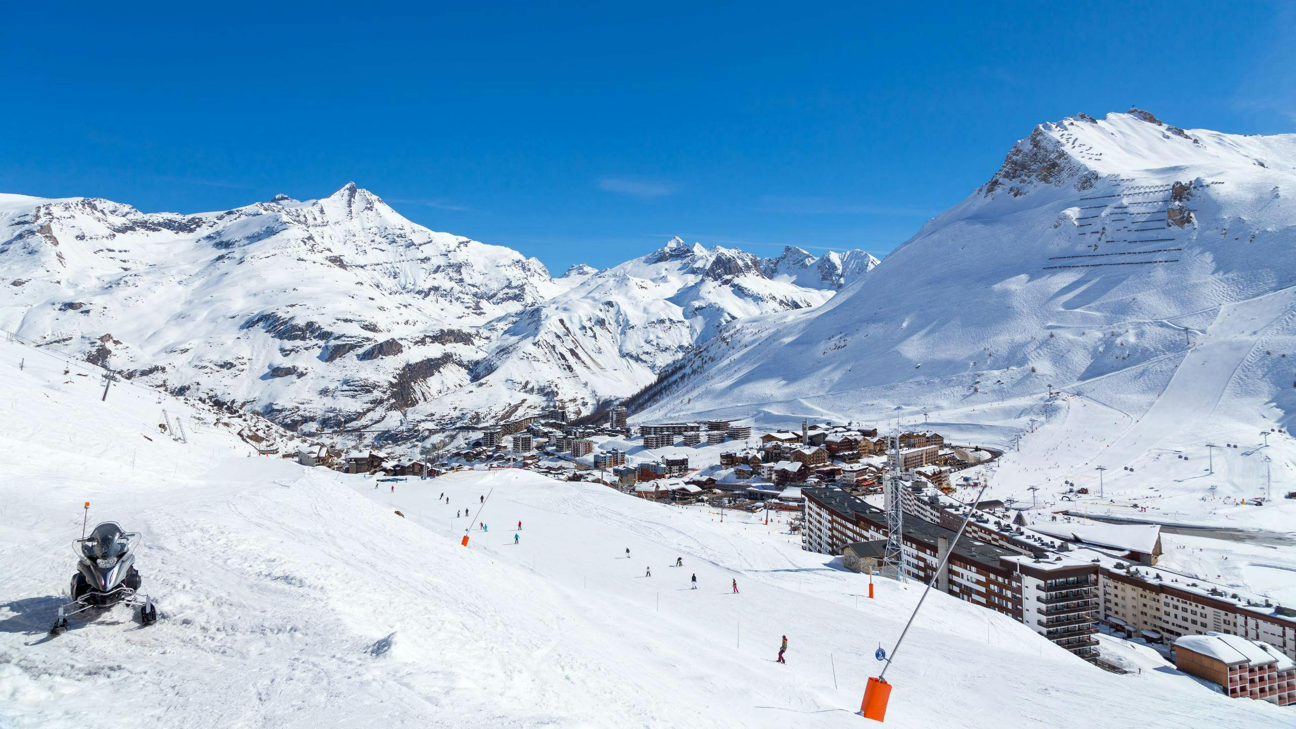 A view of the French ski resort of Tignes under the clear blue sky with its many pistes used by the local ski schools to carry out their ski lessons.